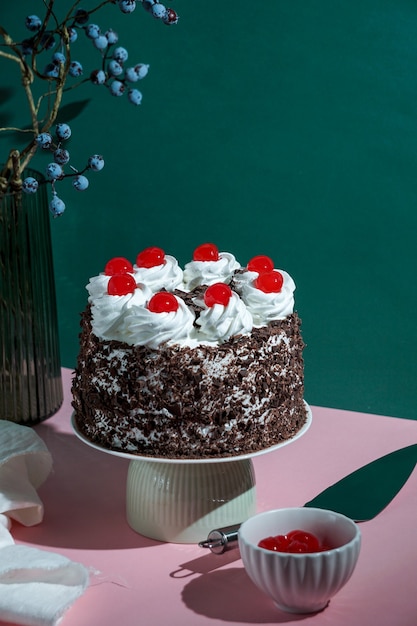 Schwarzwalder Kirschtorte, black forest cake, harsh light, table background in sunlight, modern still life, cherry dessert on modern background