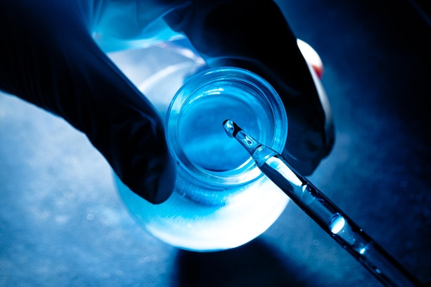 Science blue glass tube experiment,Flask in scientist hand with test tubes,Laboratory glassware