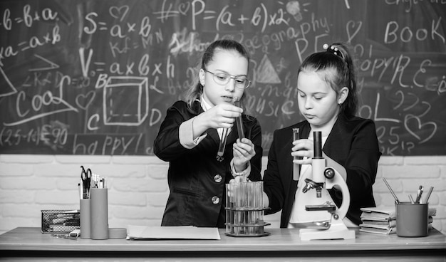 Science experiments in laboratory Biology school lesson Little scientist work with microscope Chemistry research Little girls in school lab Formal school education New ideas for medicine