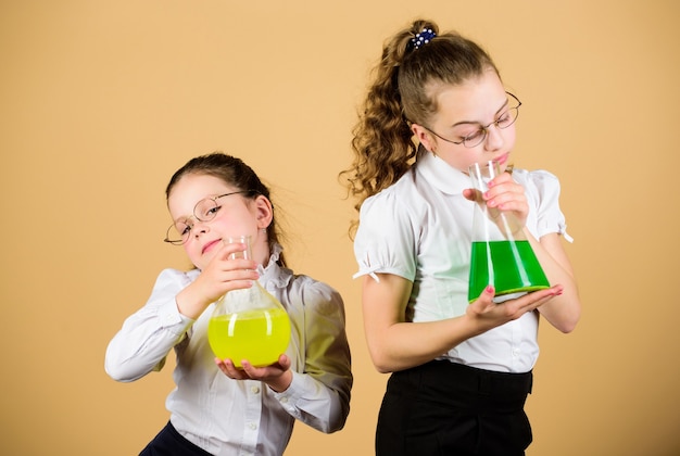 Science research in lab. knowledge and education. back to school. little smart girls with testing flask. children study at biology lesson, formal education. informal education. non formal education.