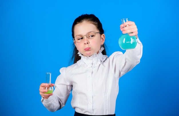 Science research in lab Small school girl child study bilogy lesson back to school education and knowledge small smart girl with testing flask Testing samples Concentrated on cure