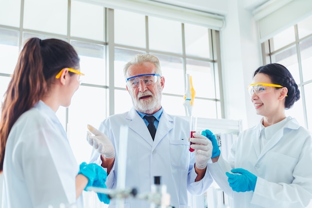 Science teacher and students team working with chemicals in lab