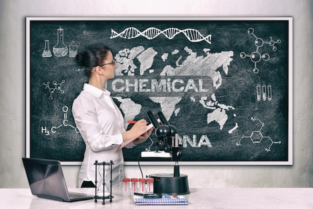 Scientific woman looking on blackboard