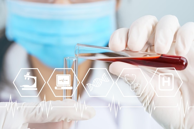 Scientist analyzing holding blood sample in test tube virus analysis