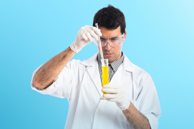 Scientist analyzing a test-tube on colorful background