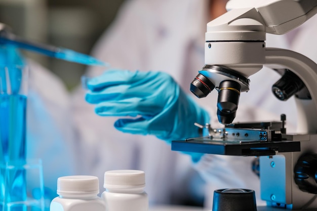 Scientist dropping a sample into a Petri dish