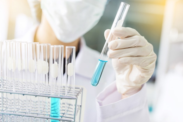 Scientist hand holding laboratory test tube, science laboratory research and development concept