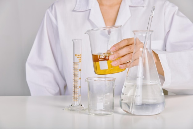 Scientist holding oil beaker Laboratory and science experiments Formulating the chemical for medical research Quality control of petroleum industry products concept