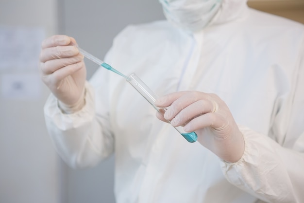 Photo scientist injecting tube