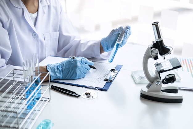 Photo scientist in lab coat working in biotechnological laboratory