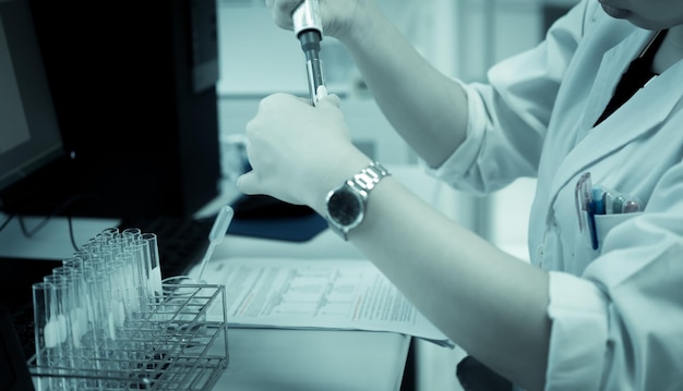 Scientist mix chemicals make experiment in the labMixture laced with samples into test tubesThailand scientist working in the lab