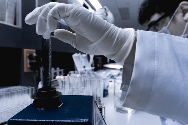 Scientist mix chemicals with The shake machine Before the experimentMixture laced with samples into test tubesThailand scientist working in the lab