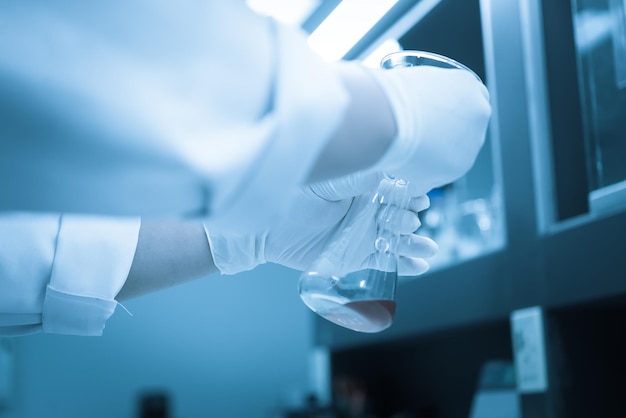 Scientist mix chemicals with The shake machine Before the experimentMixture laced with samples into test tubesThailand scientist working in the lab