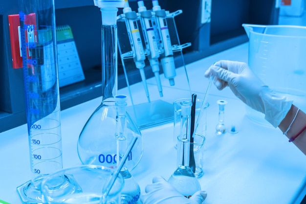 Scientist mix chemicals with The shake machine Before the experimentMixture laced with samples into test tubesThailand scientist working in the lab