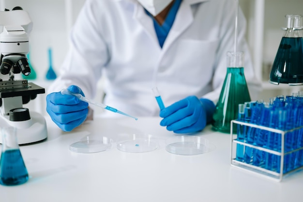 Scientist mixing chemical liquids in the chemistry lab Researcher working in the chemical a laboratoryxAxA