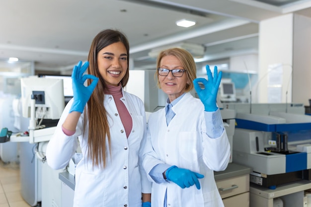 Scientist showing OK sign in research laboratory Advanced Scientific Lab for Medicine Biotechnology Microbiology Development