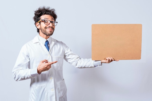 Scientist showing and pointing at a blank clipboard Professor in white coat holding and showing a blank clipboard isolated A scientist in a white coat is holding and showing a blank clipboard