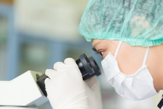 Scientist using a microscope in a laboratory, Concept science and Technology