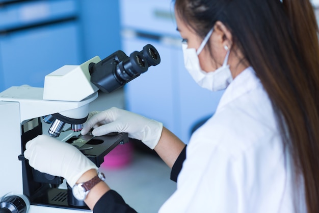 Scientist using a microscope in a laboratory 