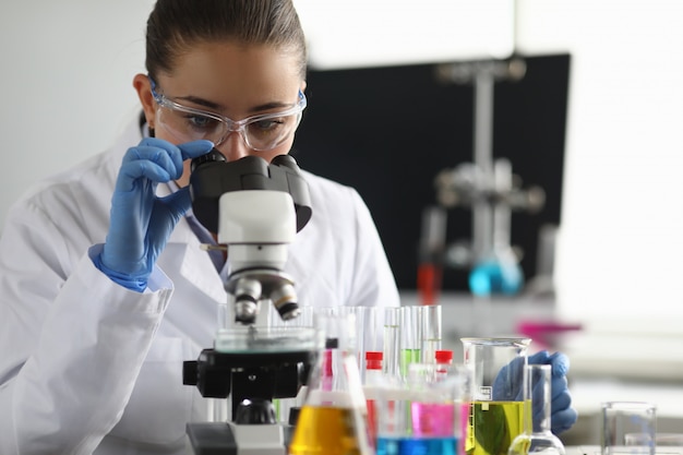 Scientist using microscope