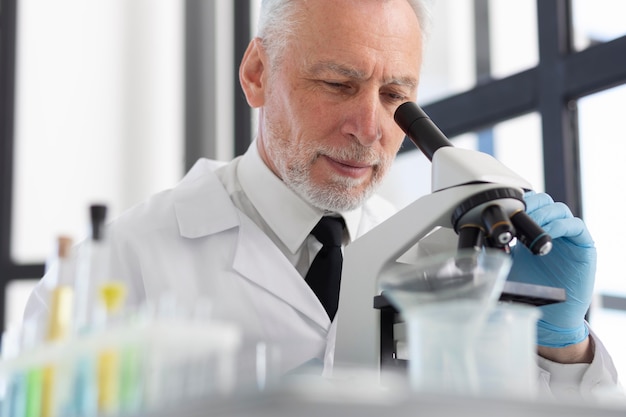 Scientist working with microscope close up