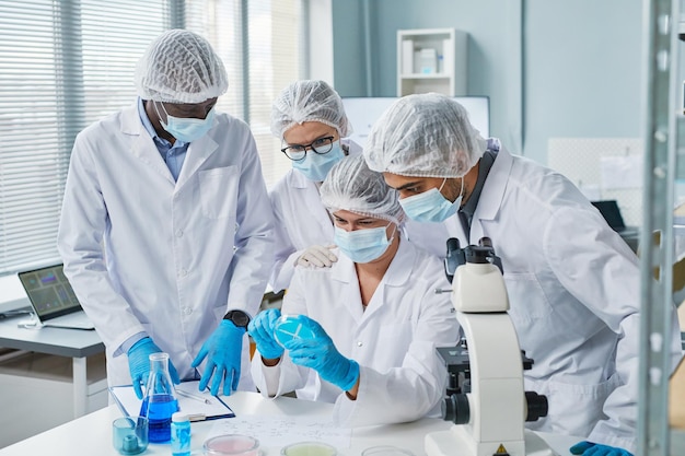 Scientists examining sample in team