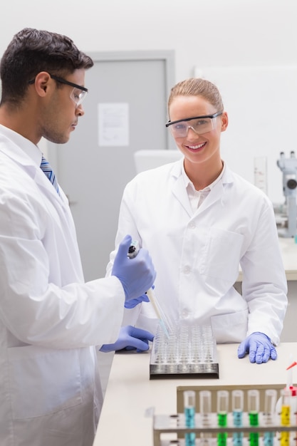 Scientists examining tubes in tray