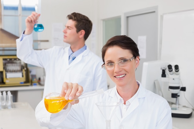 Scientists working attentively together with beakers