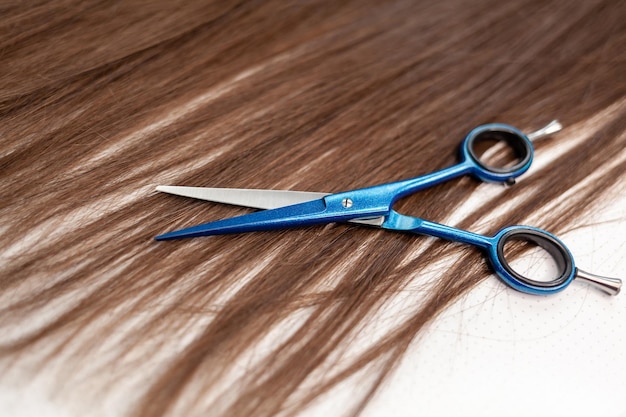 Scissors lie on the hair ribbon for extension at home