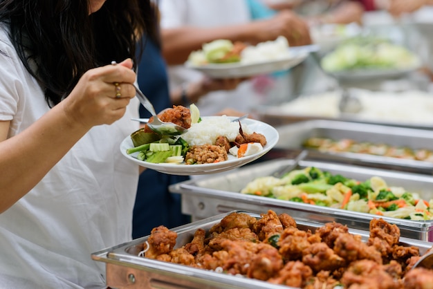 scooping the food, buffet food at restaurant, catering 