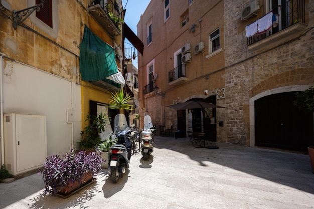 Scooters standing at the empty street of old italian town Bari Puglia South Italy