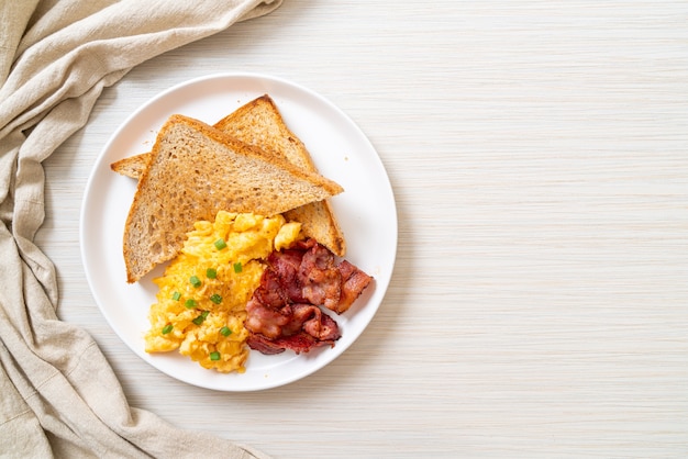 scrambled egg with bread toasted and bacon for breakfast