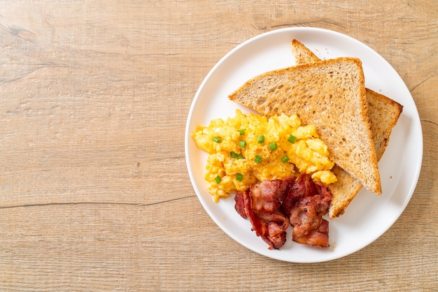 scrambled egg with bread toasted and bacon for breakfast