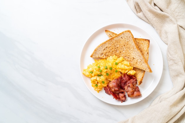 scrambled egg with bread toasted and bacon for breakfast