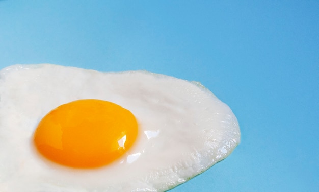 Scrambled eggs from one egg close-up on a blue .