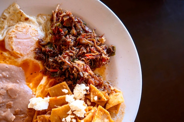 Scrambled eggs with machaca and beans and chilaquiles