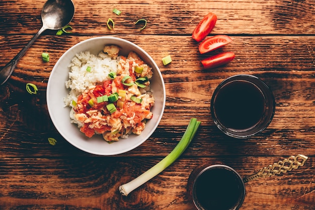 Scrambled eggs with tomatoes, leek and white rice. Turkish coffee and sliced ingredients.