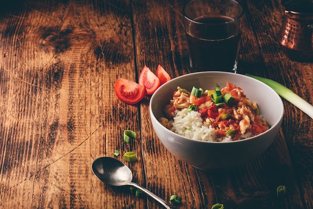 Scrambled eggs with tomatoes, leek and white rice. Turkish coffee and sliced ingredients.