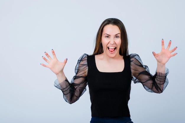 Screaming girl is opening wide her hands on white background