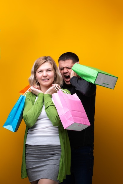 Screaming man and woman with shopping bags