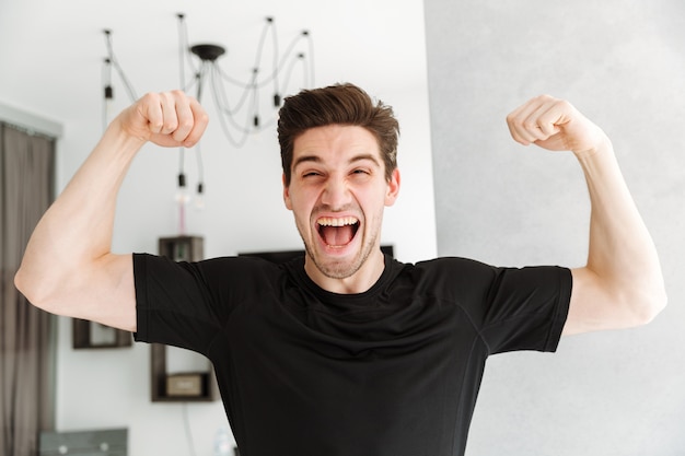 Screaming young man standing in home