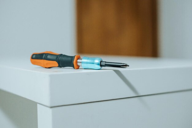 Screwdriver over furniture with copy space Moving home concept new life work concept Construction freelance work