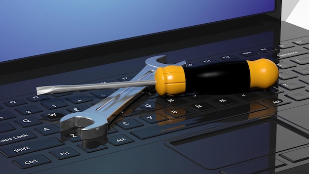 Photo screwdriver and wrench on laptops keyboard