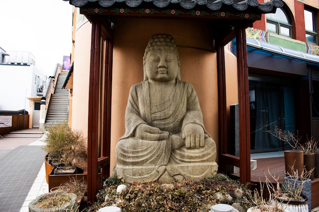 Sculpture carving big stone buddha statue tibet style for korean people travelers travel visit and respect praying at Diamond Busan Tower and Yongdusan park on February 18 2023 in Busan South Korea