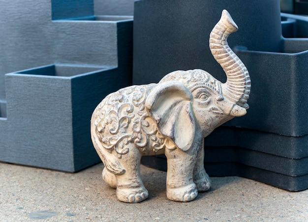 Sculpture of Indian elephant with raised trunk weathered stone Large figurine for garden decoration standing outdoor Religious decoration of African elephant in the garden Decorative figurine