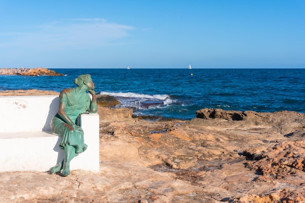 The sculpture of the woman looking at the sea on the Paseo Juan Aparicio in Torrevieja Alicante