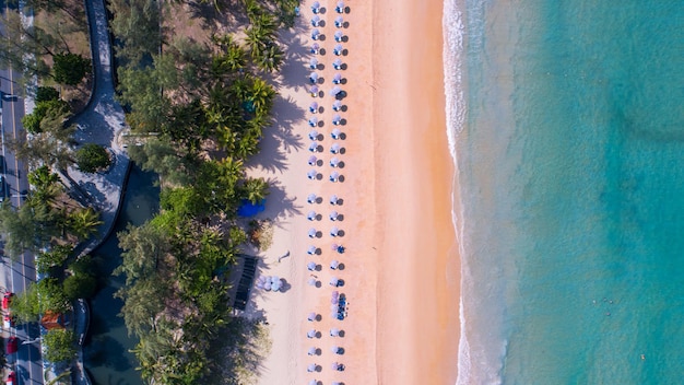 Sea background Aerial view Top down sea waves crashing on sandy beach beautiful sand sea surface in Phuket thailand