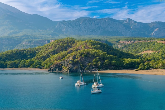 Sea bay among the mountains with some yachts, view of the South Harbor of the ancient city of Phaselis, Turkey