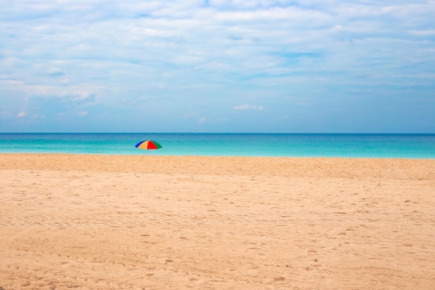 Sea beach and sandy shore with sun umbrella Rest and relaxation on holiday at the resort