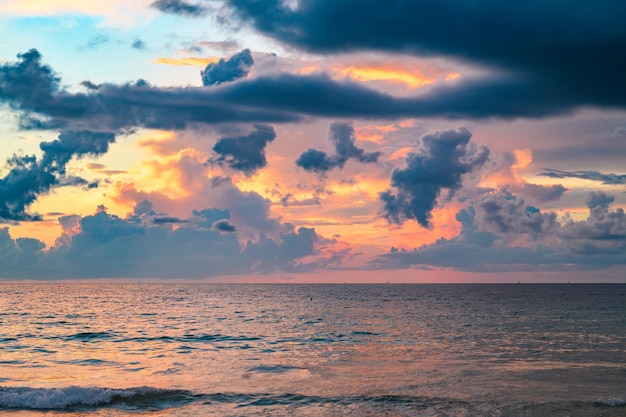 Sea beach with sky sunset or sunrise cloudscape over the sunset sea dramatic slouds sunset at tropic